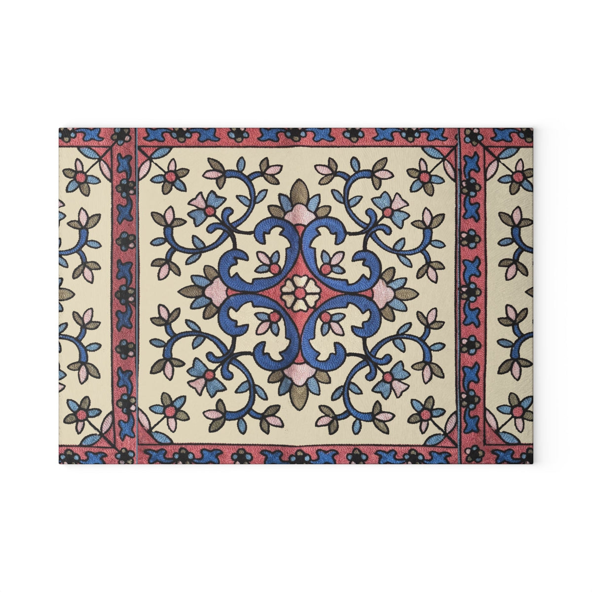 Blue and pink Armenian floral cutting board on a wooden worktop with a knife alongside