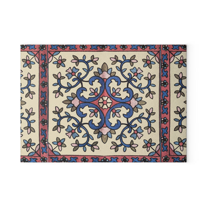 Blue and pink Armenian floral cutting board on a wooden worktop with a knife alongside