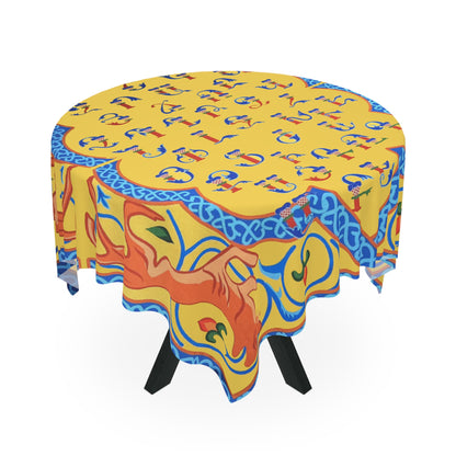 Yellow Armenian alphabet tablecloth draped over a round table beside a window
