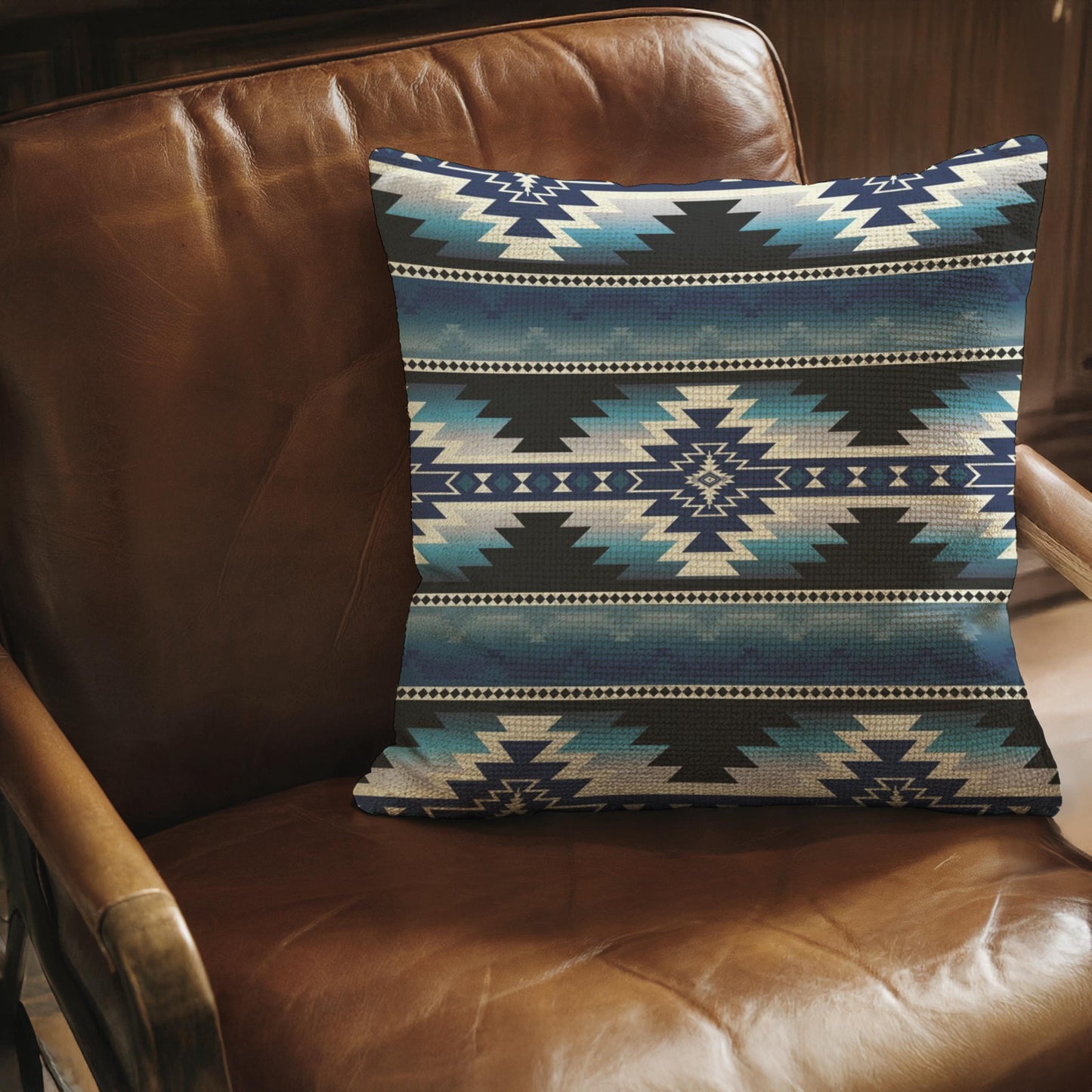 Southwestern throw pillow with geometric pattern styled on a sofa or bed
