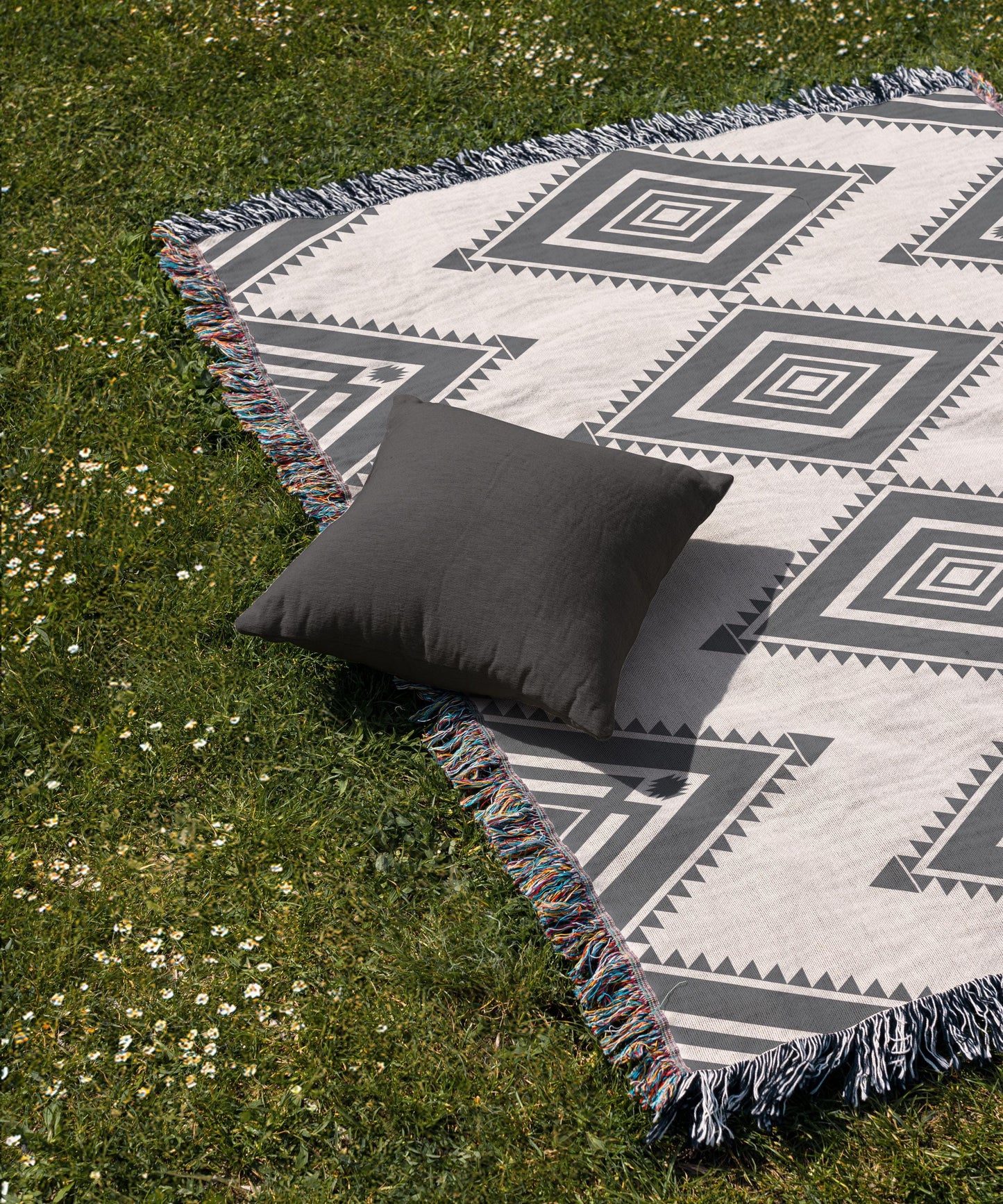 Southwestern woven blanket with geometric pattern styled for layered home decor