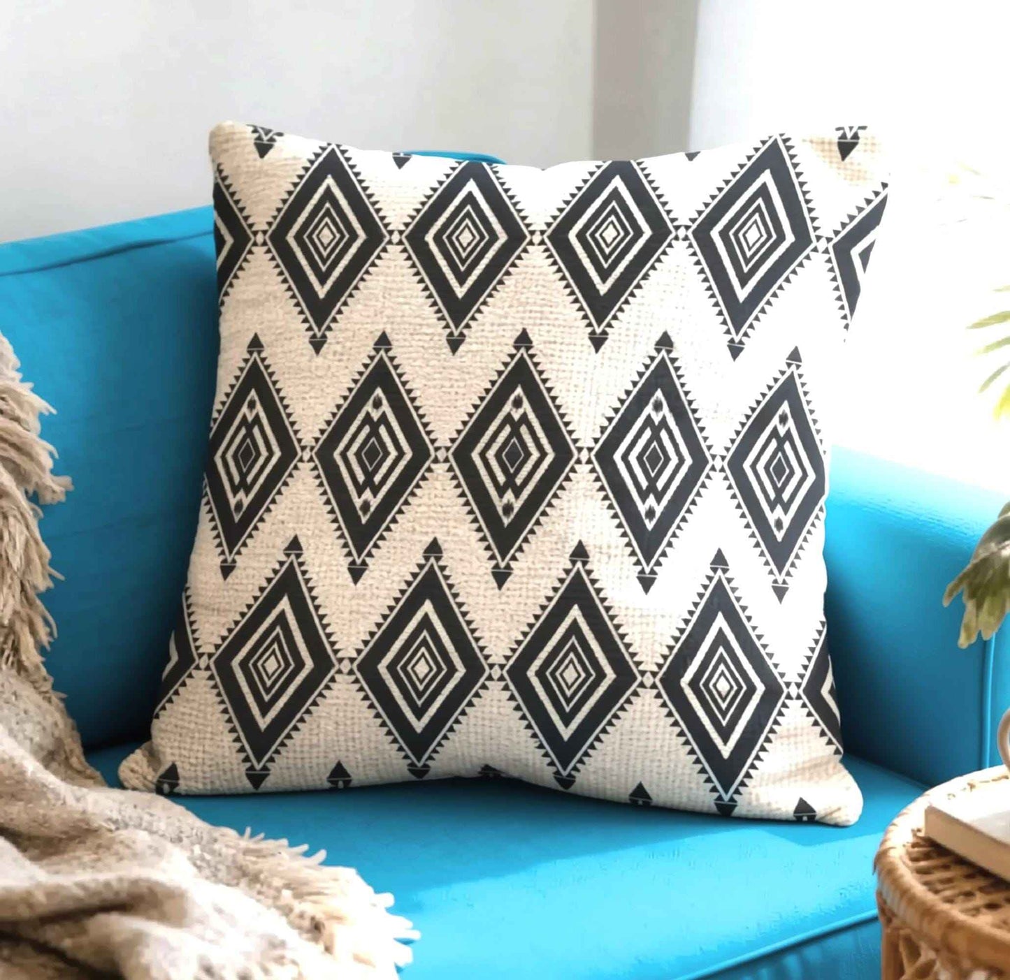 Southwestern throw pillow with geometric pattern styled on a sofa or bed