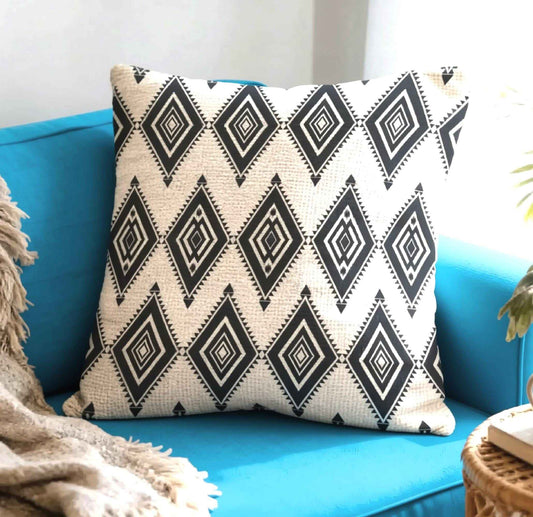 Southwestern throw pillow with geometric pattern styled on a sofa or bed