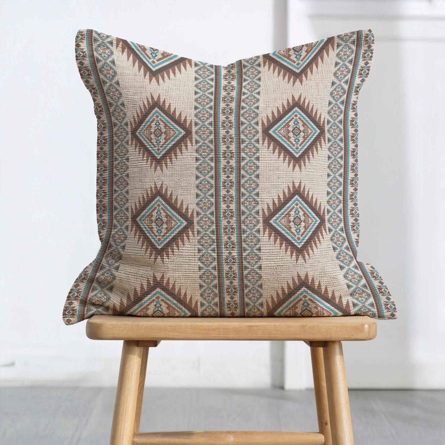 Southwestern throw pillow with geometric pattern styled on a sofa or bed