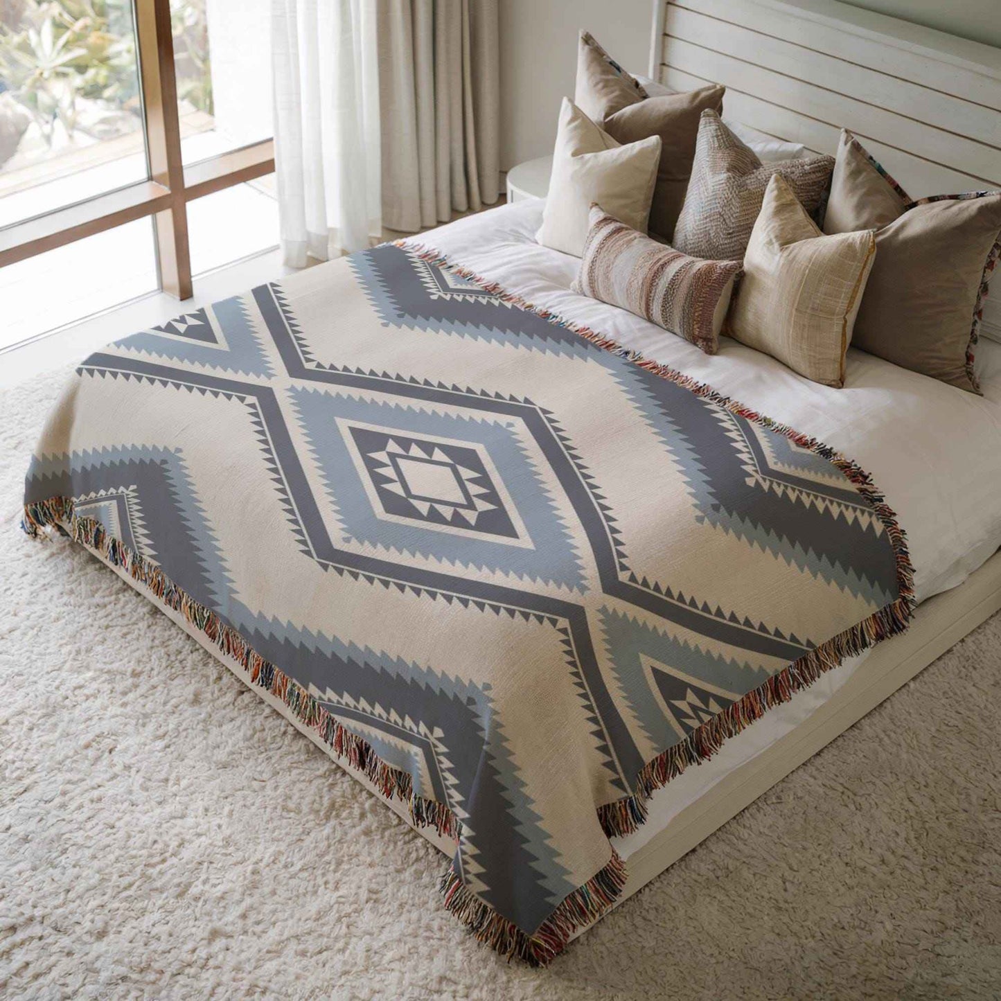Southwestern woven blanket with geometric pattern styled for layered home decor