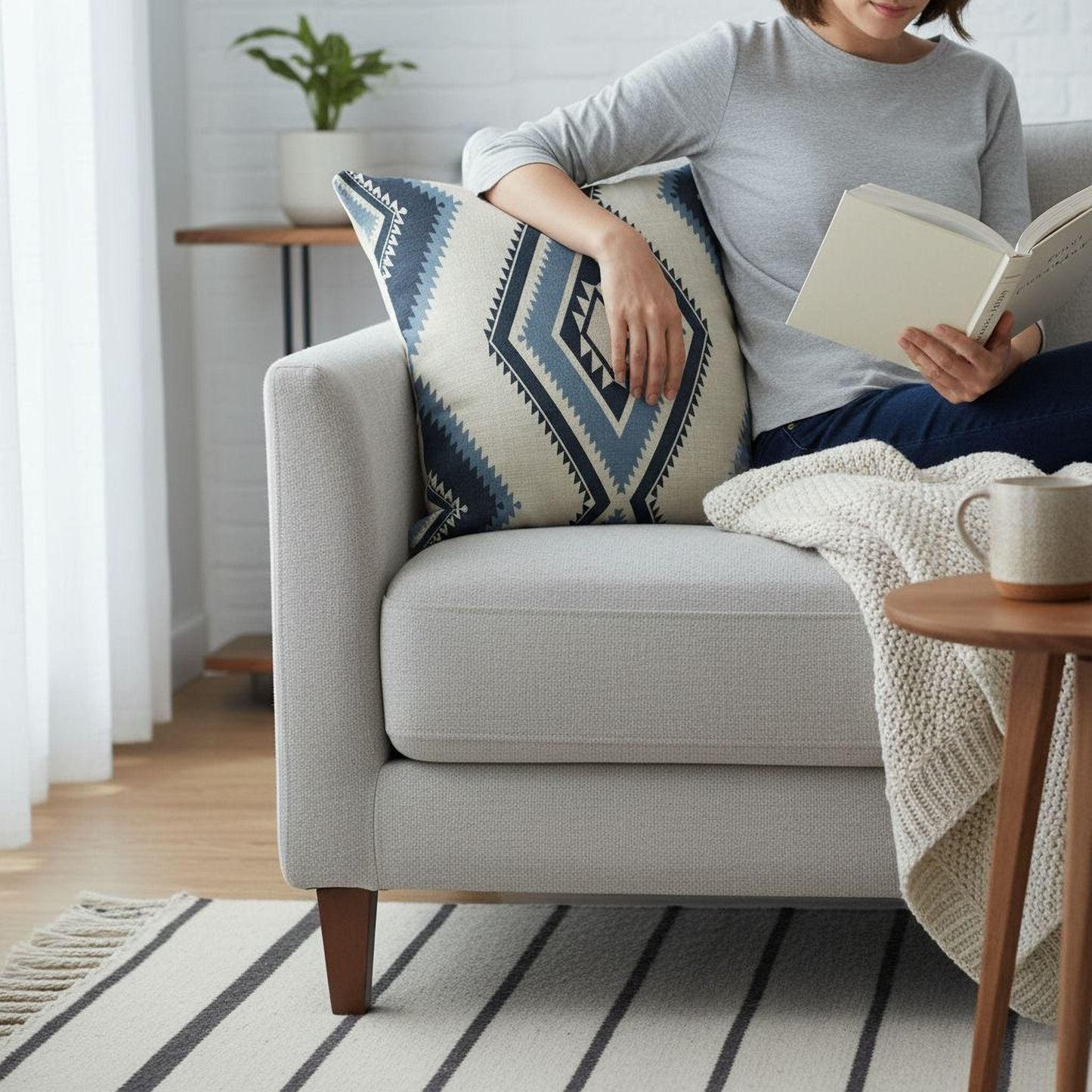 Southwestern pillow cover with geometric pattern styled on a sofa or bed