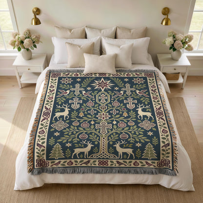 Armenian deer and pomegranate blanket spread over a bed with white pillows and flowers on the nightstands