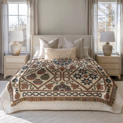 Rust and teal woven cotton bed throw blanket, close view of the geometric pattern
