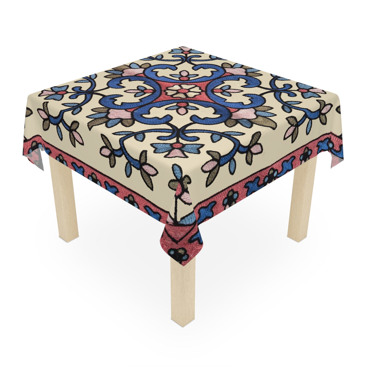 Cream Armenian floral tablecloth draped over a round table beside a window