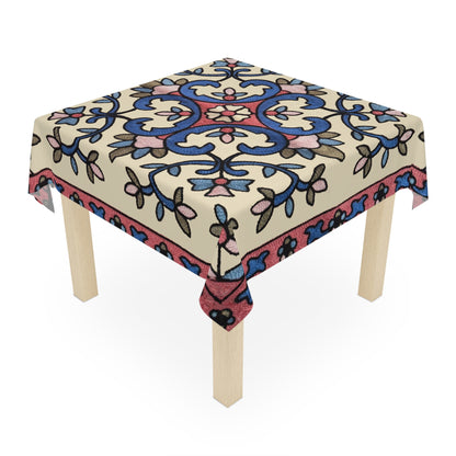 Cream Armenian floral tablecloth draped over a round table beside a window