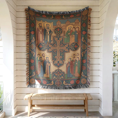 Armenian Christian wall tapestry on white shiplap, ornate cross center, muted teal, rust and cream, fringed hem above bench