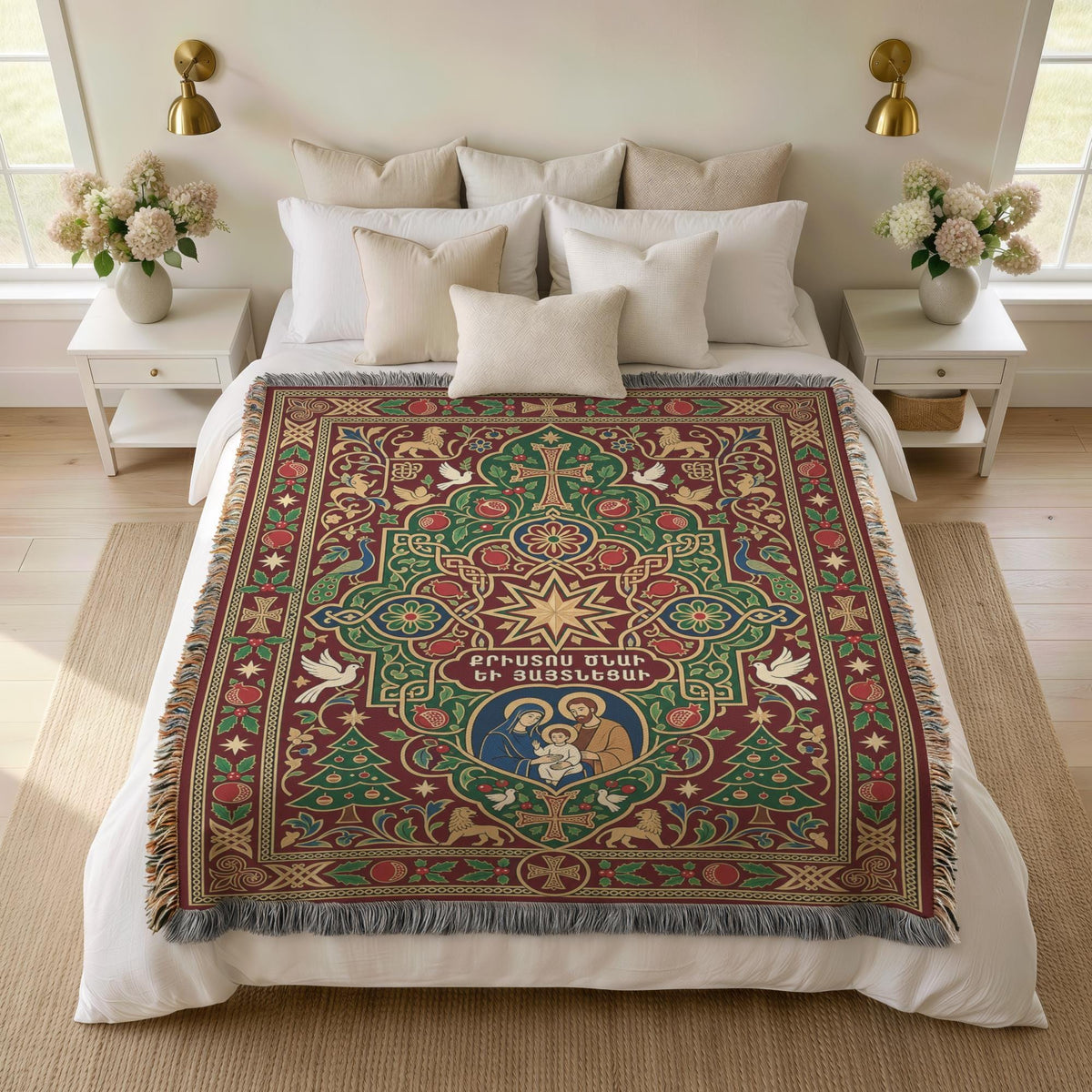 Armenian Nativity star and dove woven blanket spread over a bed with white pillows and a vase of flowers