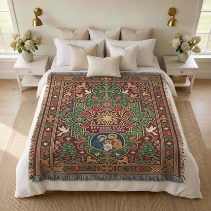 Armenian Nativity star and dove woven blanket spread over a bed with white pillows and a vase of flowers