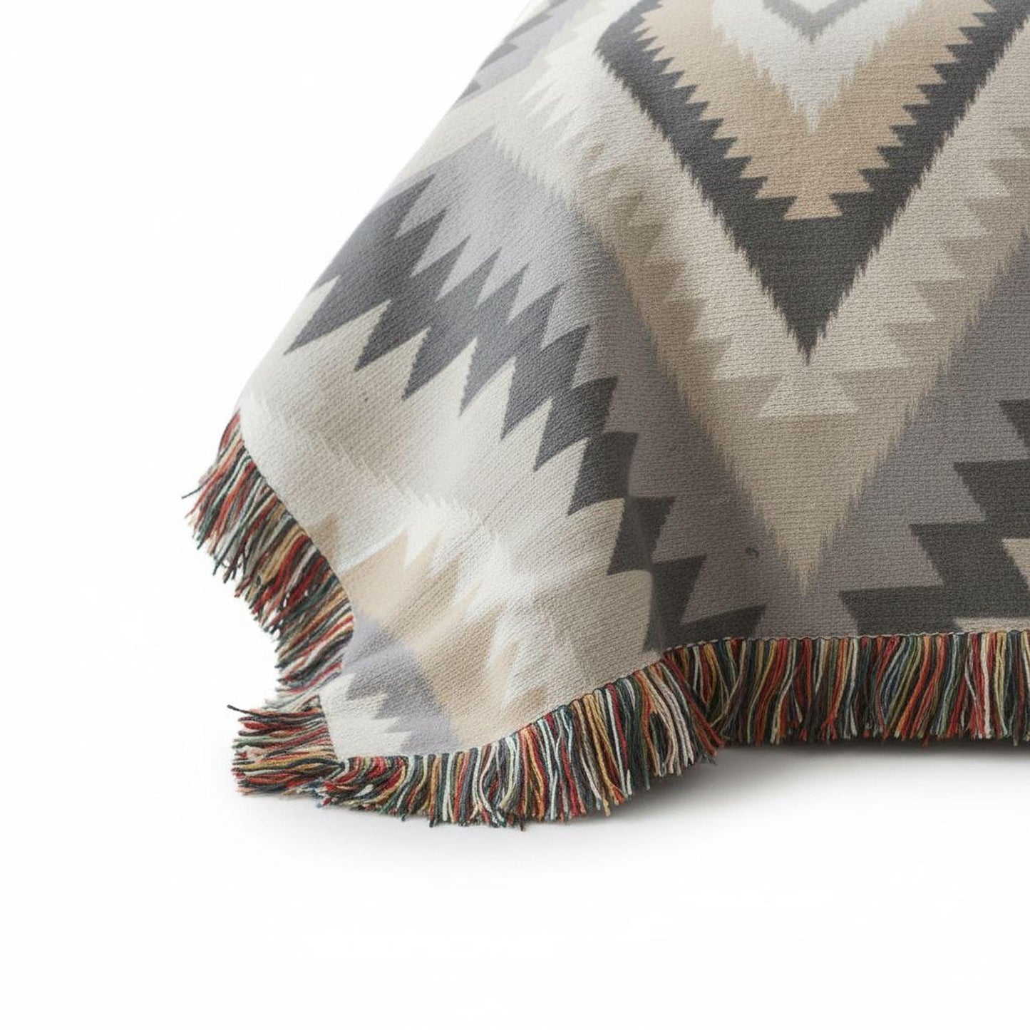 Southwestern woven blanket with geometric pattern styled for layered home decor