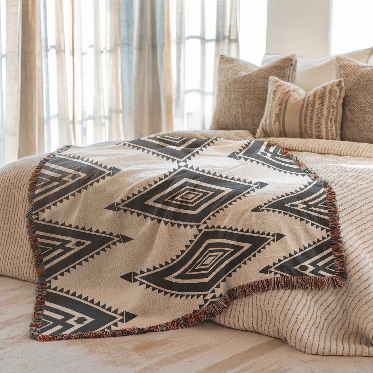 Southwestern woven blanket with geometric pattern styled for layered home decor