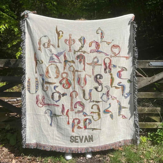 Boho woven blanket with woven pattern styled for layered home decor