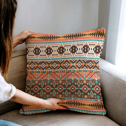 Southwestern throw pillow with geometric pattern styled on a sofa or bed
