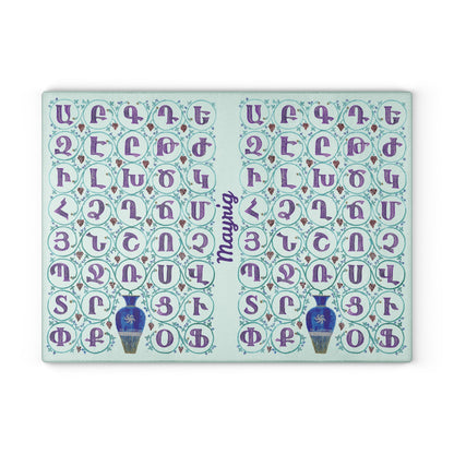 Mint Armenian alphabet cutting board with blue vases seen from above on a kitchen counter