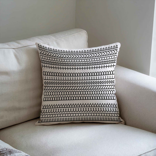 Modern Geometric throw pillow with geometric pattern styled on a sofa or bed