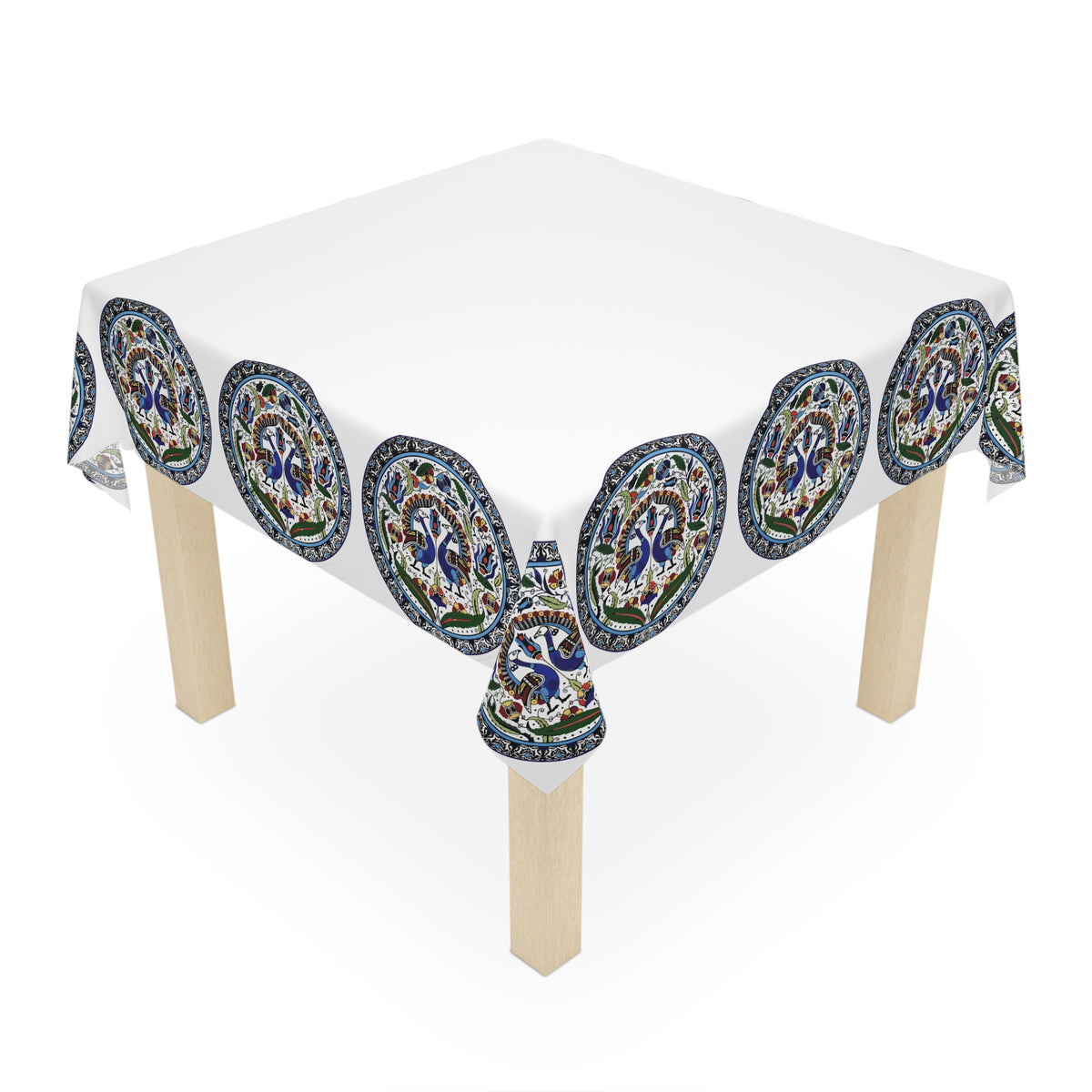 Armenian peacock medallion tablecloth on a round dining table with a vase and a bowl of fruit