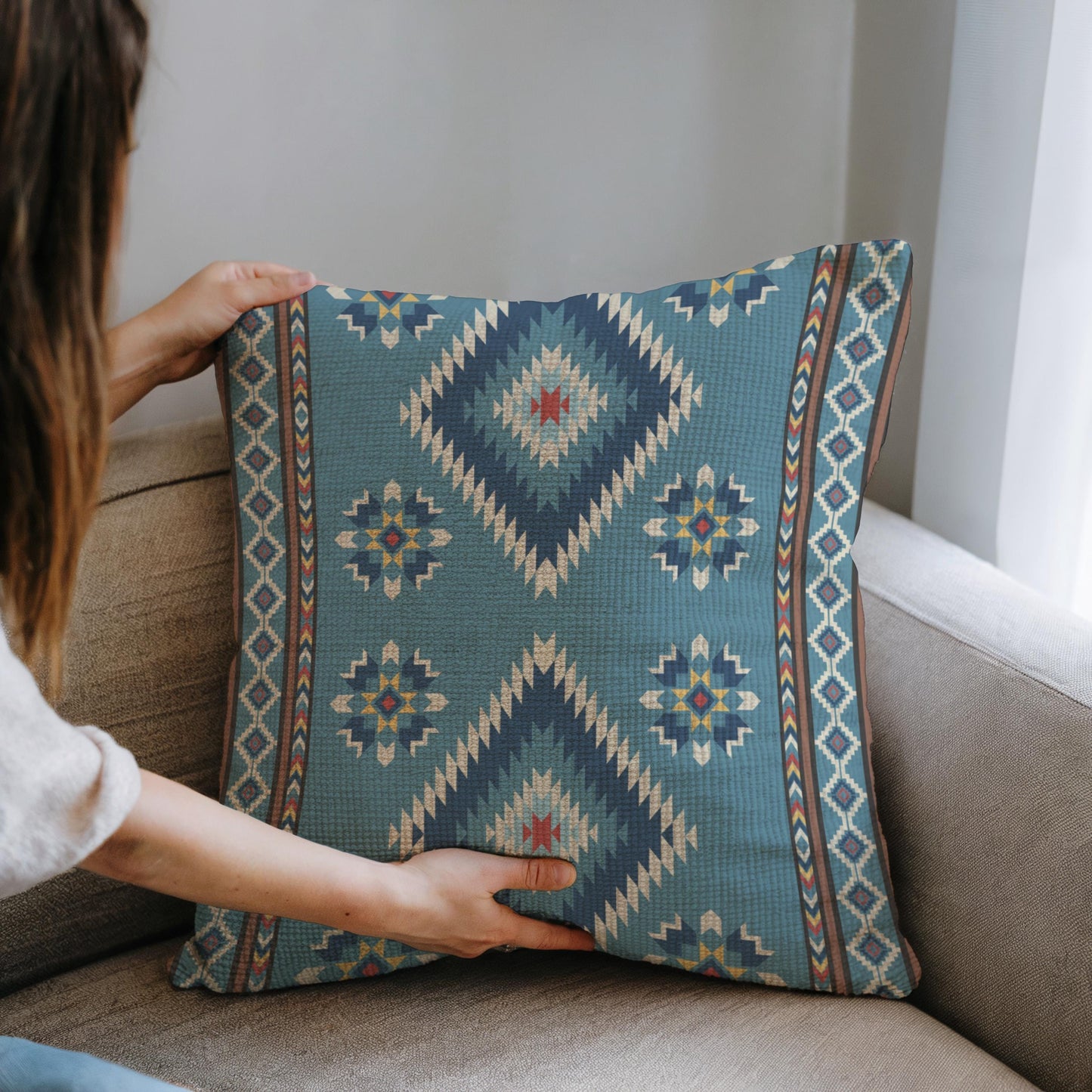 Southwestern throw pillow with geometric pattern styled on a sofa or bed