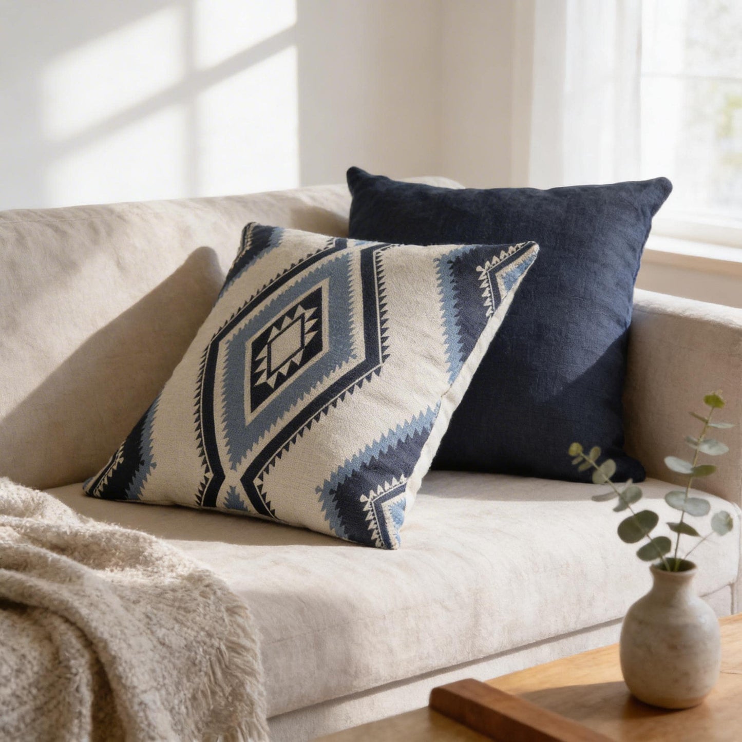 Southwestern pillow cover with geometric pattern styled on a sofa or bed