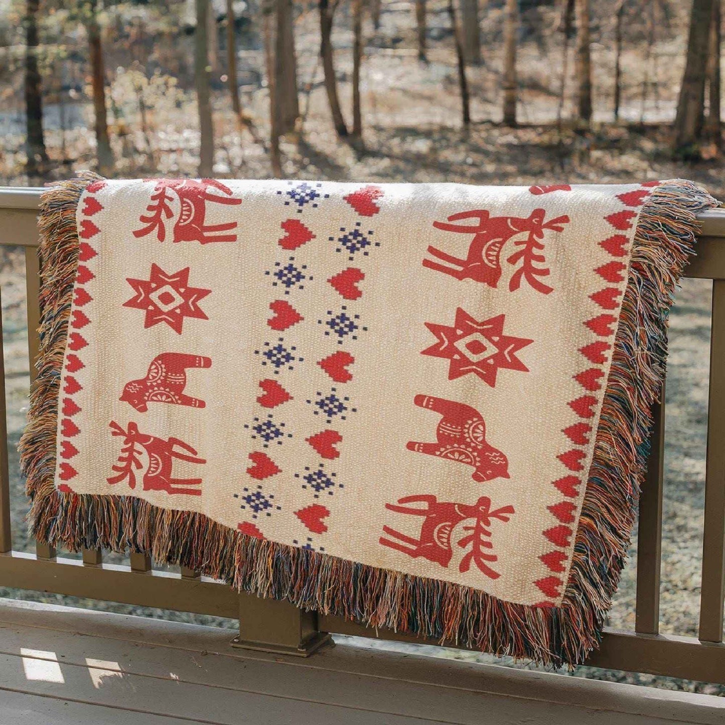 Scandinavian Inspired woven blanket with rug-style pattern styled for layered home decor