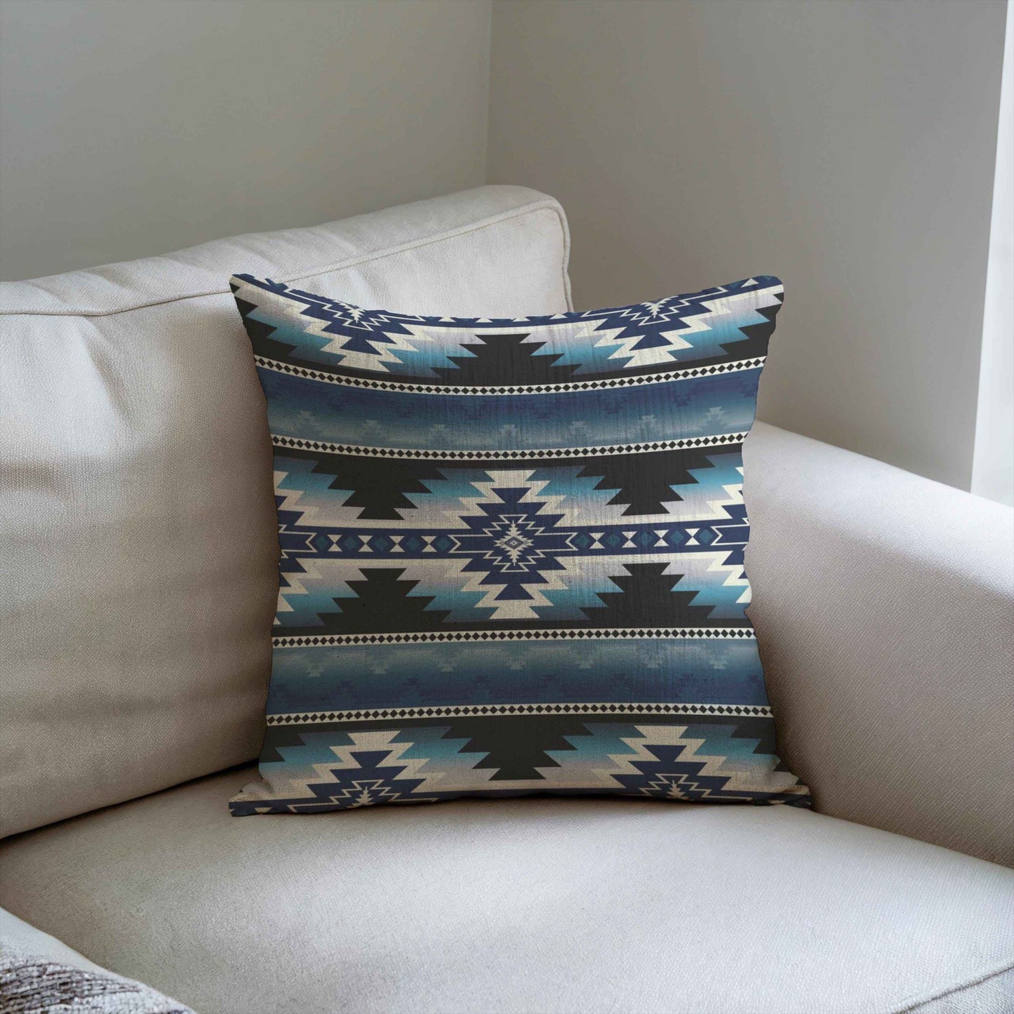 Southwestern throw pillow with geometric pattern styled on a sofa or bed