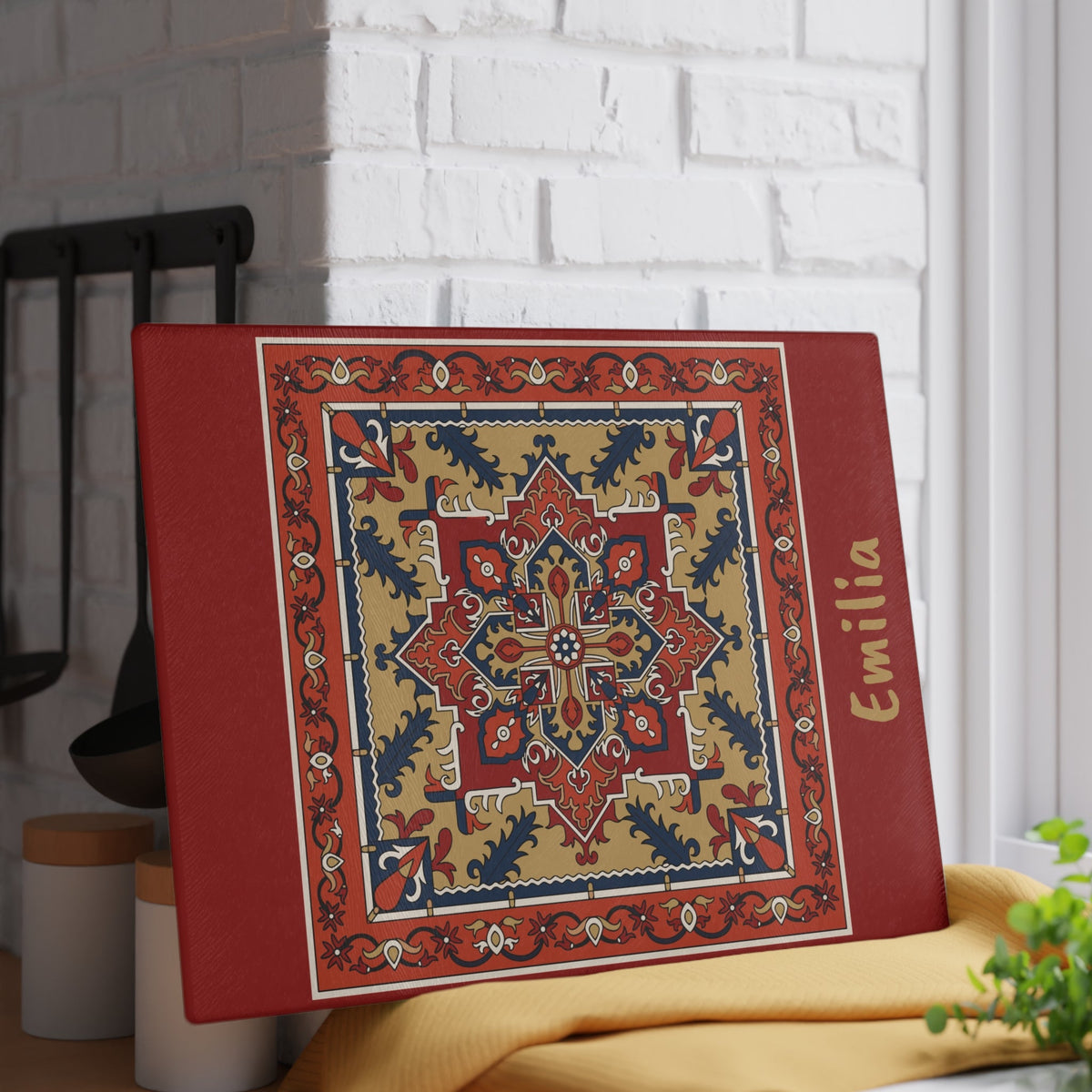 Red Armenian rug cutting board with a gold name close view showing the pattern