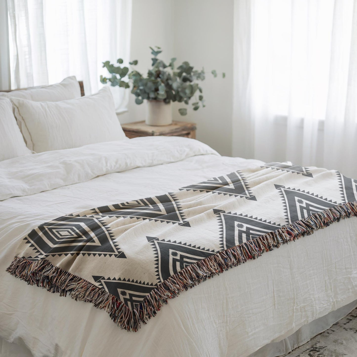 Southwestern woven blanket with geometric pattern styled for layered home decor