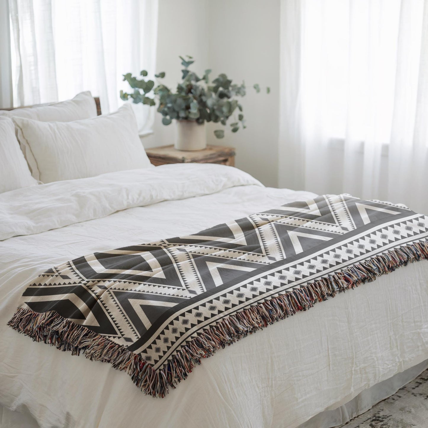 Southwestern woven blanket with geometric pattern styled for layered home decor
