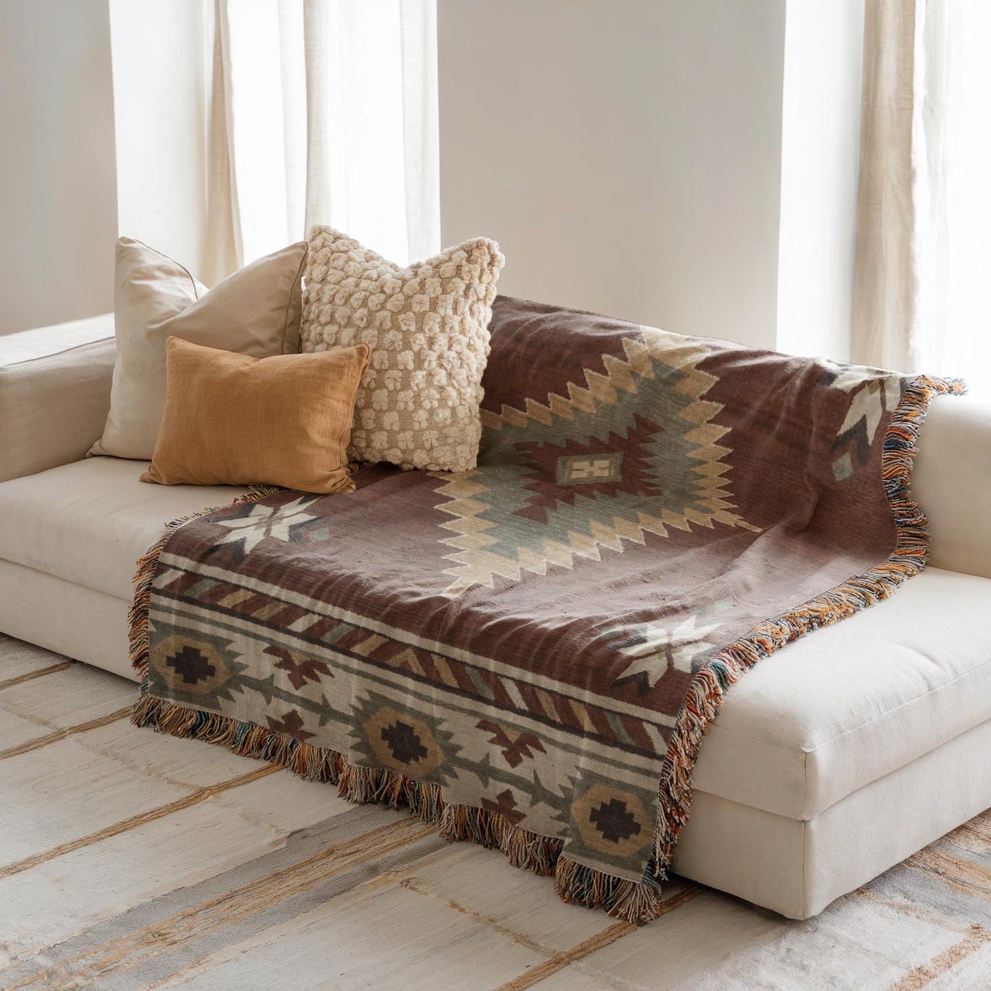Southwestern woven blanket with geometric pattern styled for layered home decor