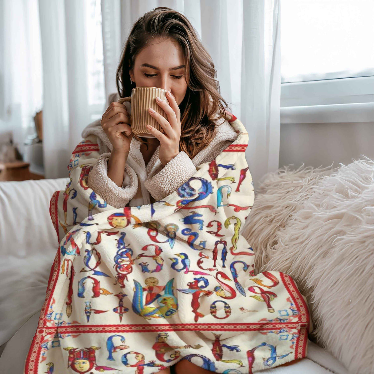 Armenian alphabet plush blanket, letters drawn as birds and animals in red, blue and gold on cream