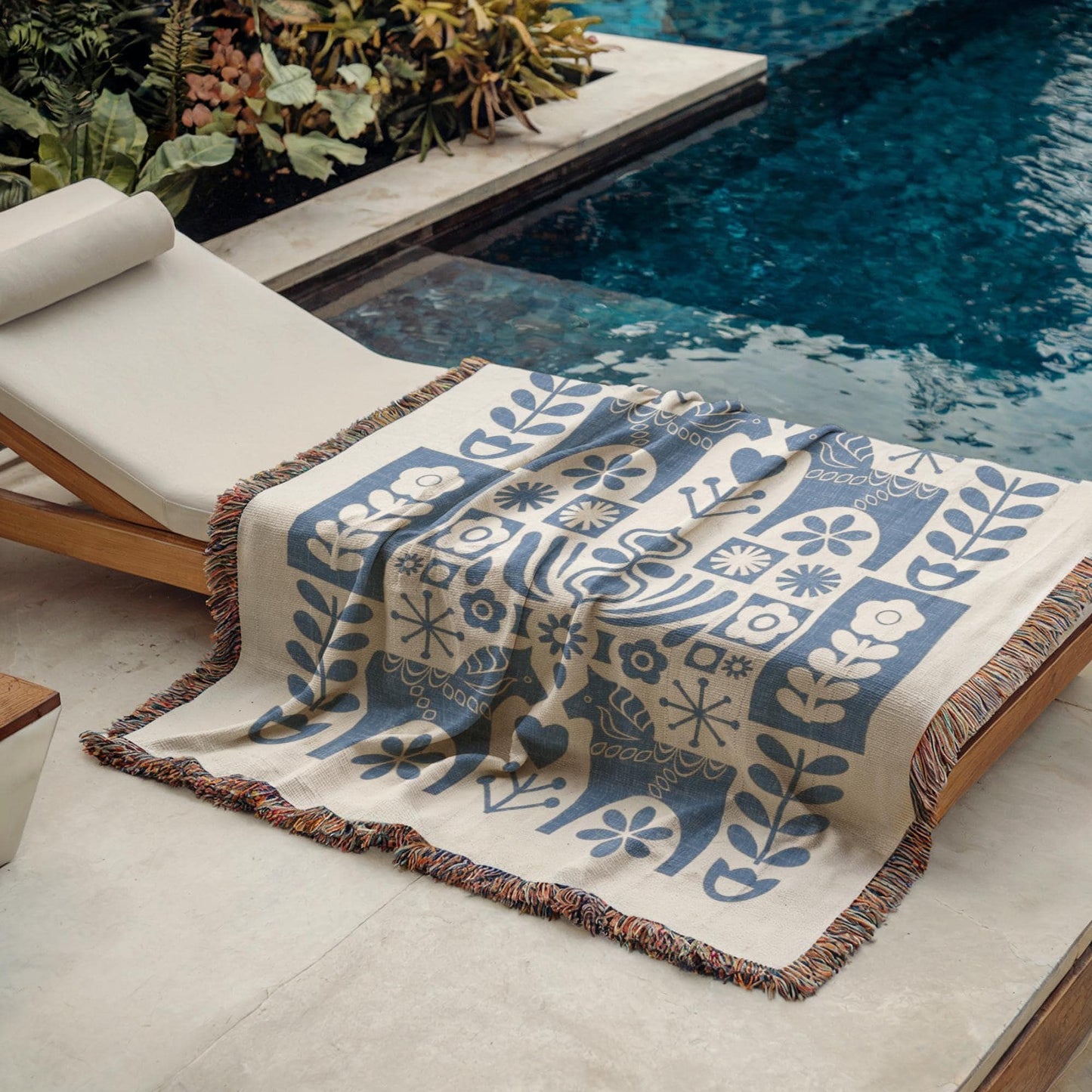 Scandinavian Inspired woven blanket with rug-style pattern styled for layered home decor