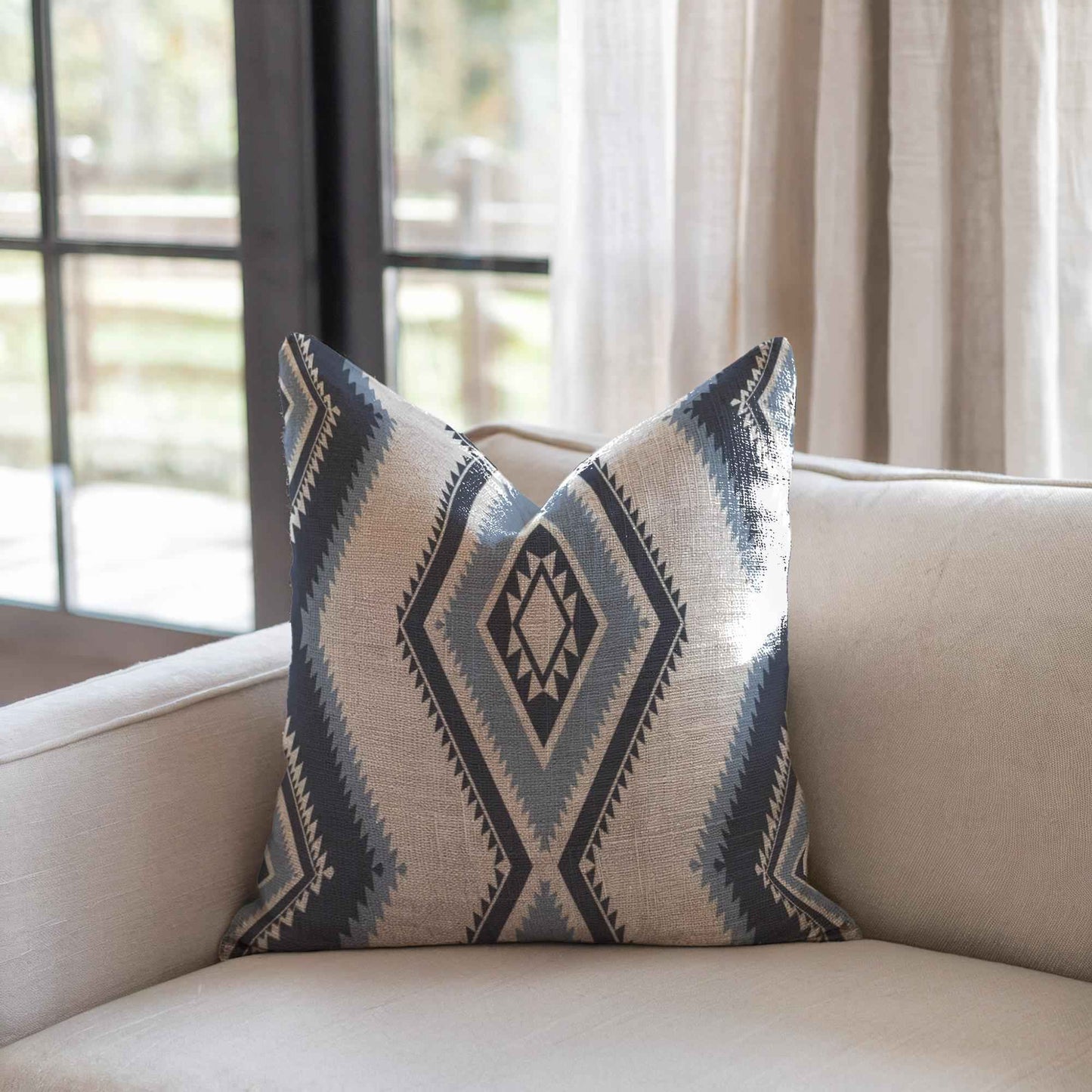 Southwestern pillow cover with geometric pattern styled on a sofa or bed