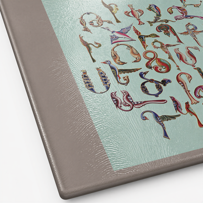 Close view of the Trchnakir bird letters in blue and gold on the mint glass surface