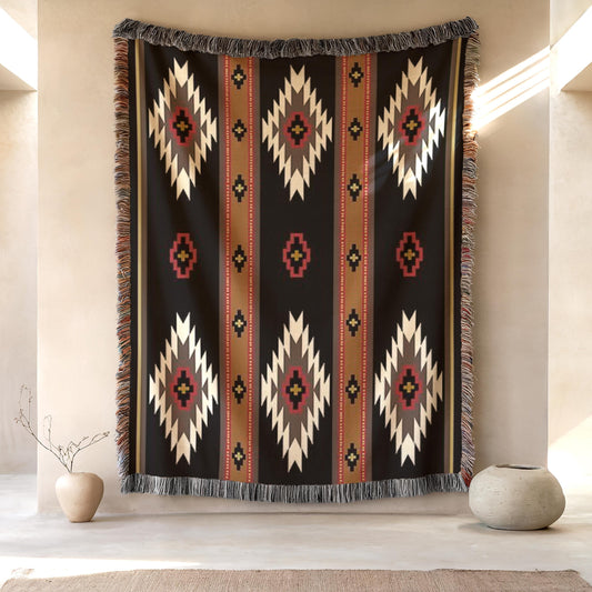 a large, colorful, and intricate rug hanging on a wall, with a small vase and a plant placed in front of it.