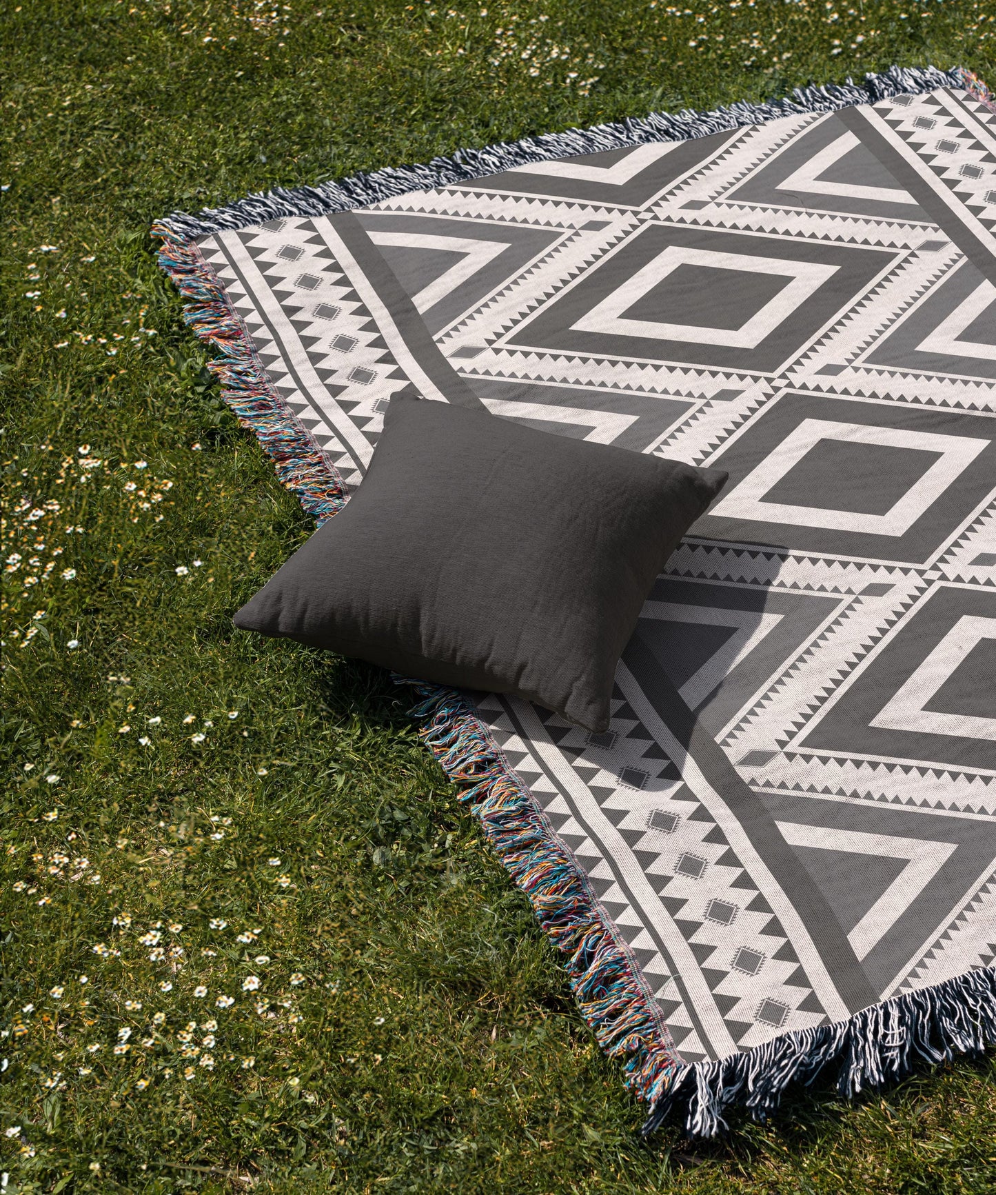 Southwestern woven blanket with geometric pattern styled for layered home decor