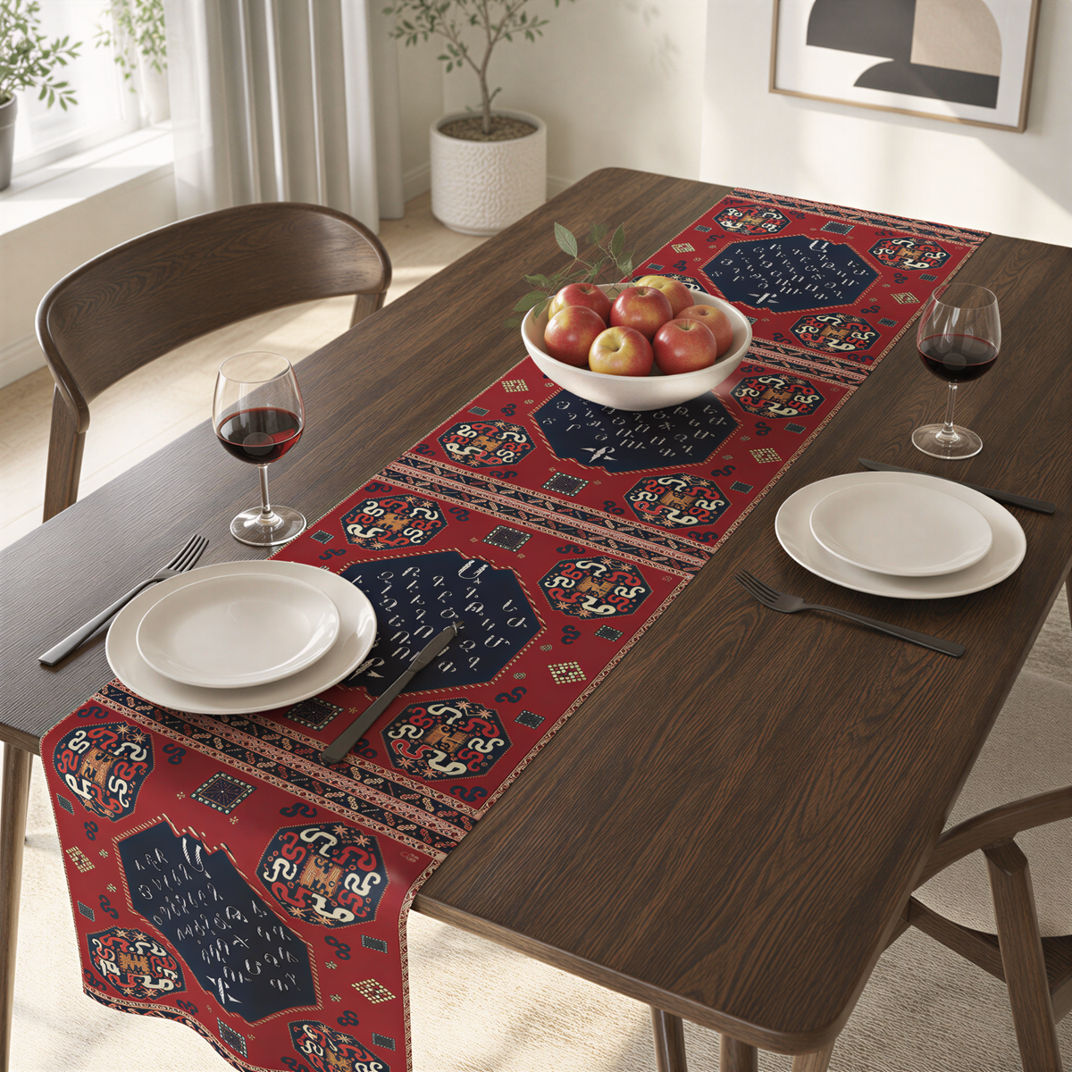 Armenian alphabet table runner in deep red on a dining table with wooden chairs and a bowl of fruit