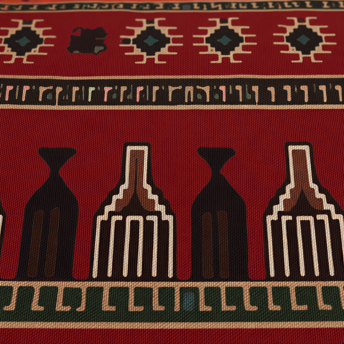 Close view of the red carpet bands with cream comb motifs, stars and a dark green border