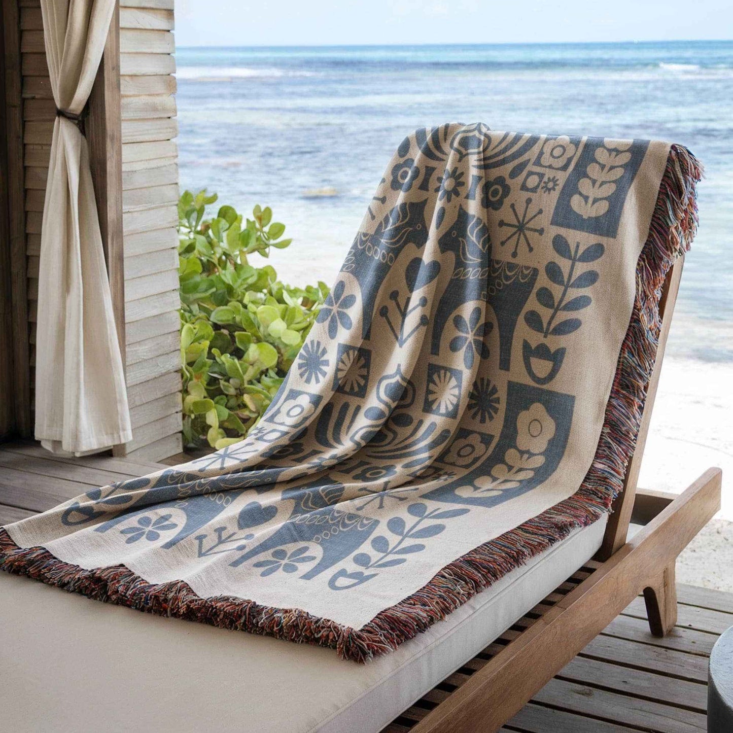 Scandinavian Inspired woven blanket with rug-style pattern styled for layered home decor
