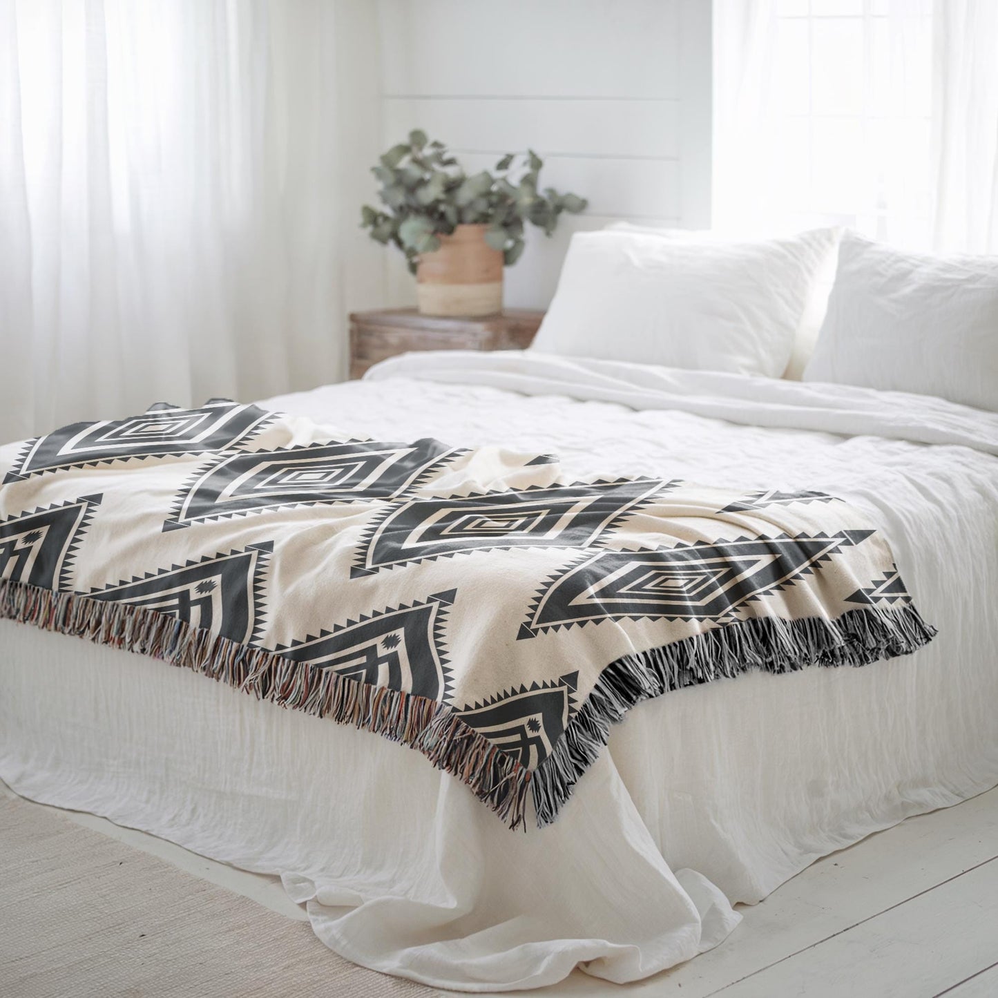 Southwestern woven blanket with geometric pattern styled for layered home decor