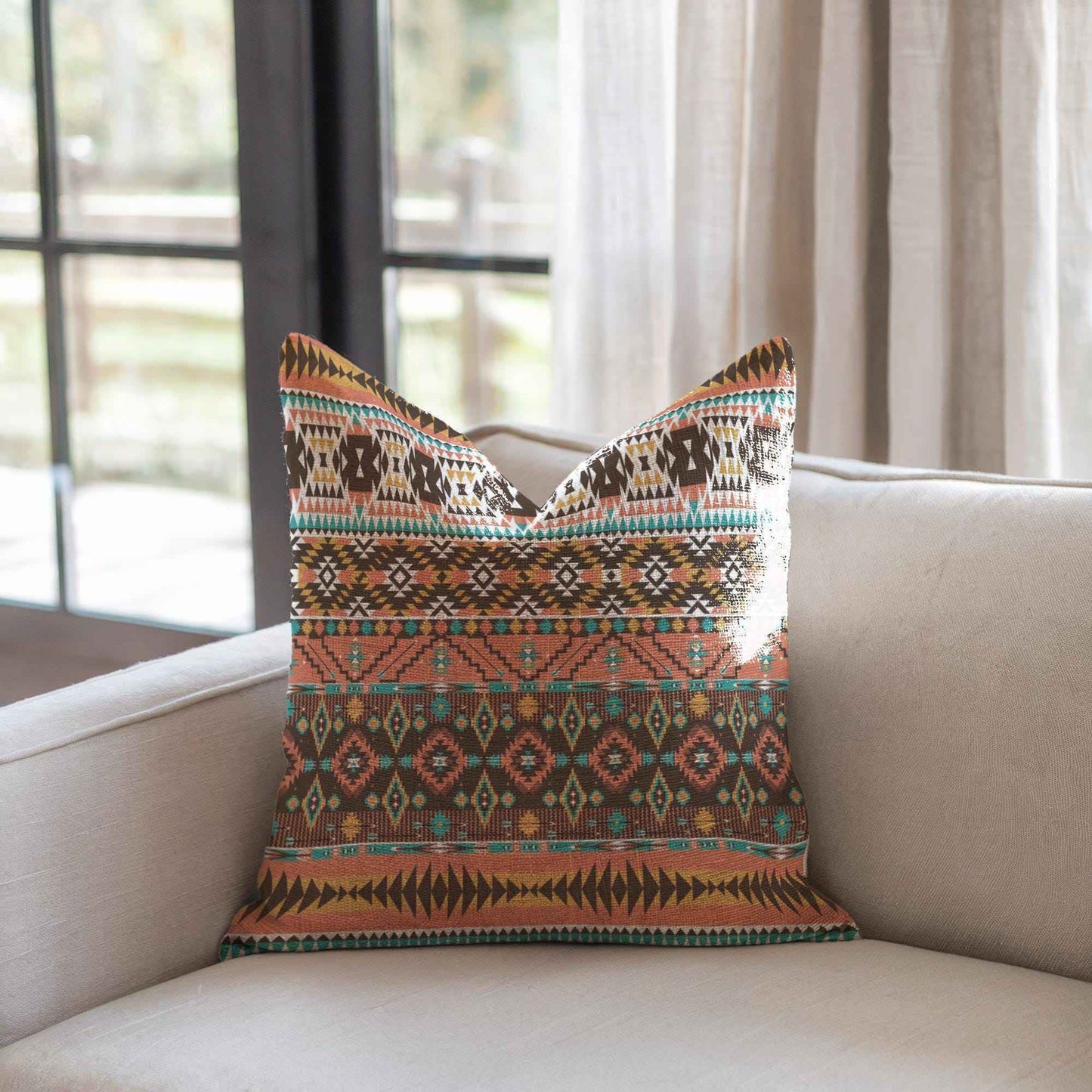 Southwestern throw pillow with geometric pattern styled on a sofa or bed