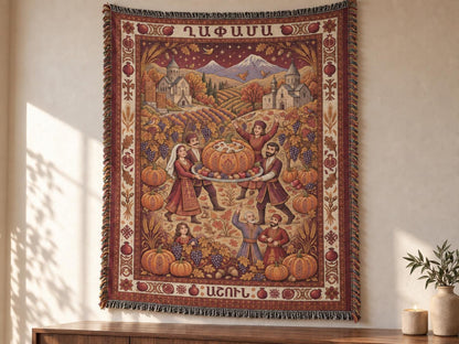 Family Ghapama cotton blanket hanging as a wall tapestry, with pumpkin harvest artwork, mountains, Armenian lettering and decorative fringe.