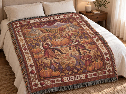 Armenian autumn family blanket spread across a bed, with a central stuffed pumpkin celebration and muted burgundy, cream and gold woven details.