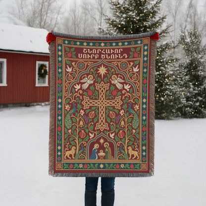 Armenian cross and Nativity woven blanket held up outdoors in the snow beside a red building with Christmas lights