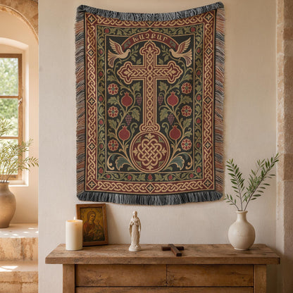 Khachkar tapestry with doves and pomegranates on a plaster wall beside an arched window and potted plants