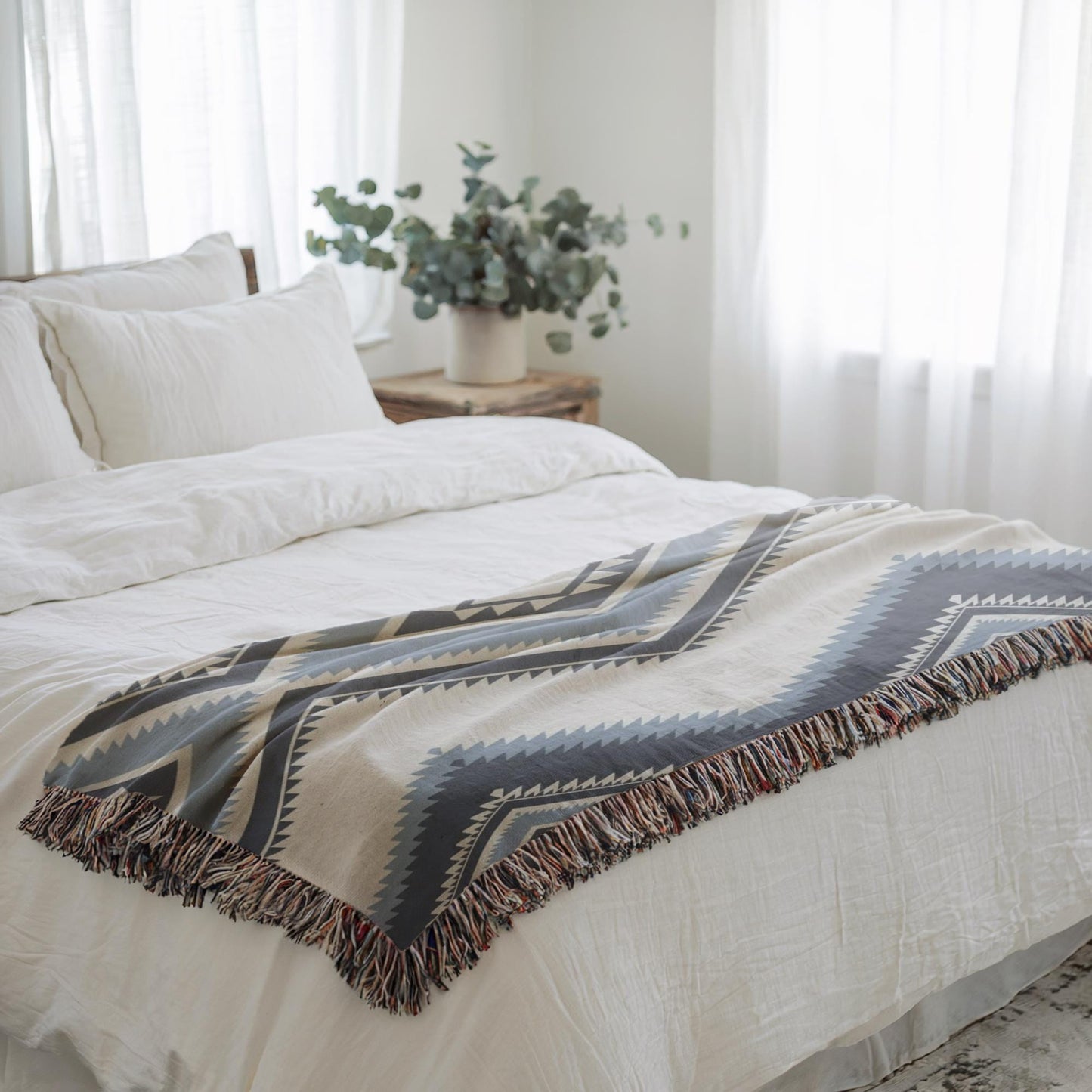 Southwestern woven blanket with geometric pattern styled for layered home decor