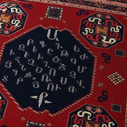 Close view of Armenian letters in a navy oval medallion on deep red