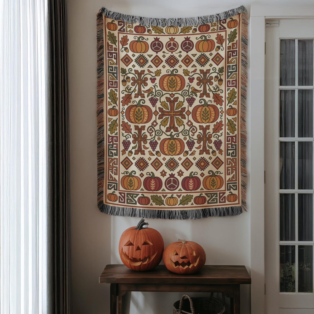Armenian Ghapama woven blanket hung on a wall above two carved pumpkins